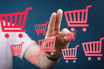 Hand interacting with virtual shopping carts, symbolizing online shopping, e-commerce, and digital...