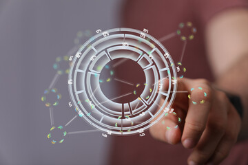 Person interacts with a futuristic digital interface showing data analysis and visualization.