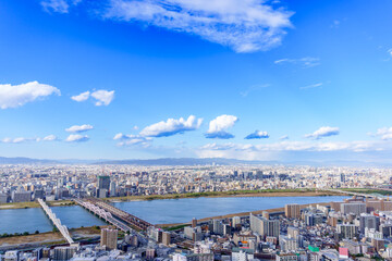 Aerial view of Osaka city and Yodo river and bridges from Umeda Sky Building with blue sky, Osaka, Japan.