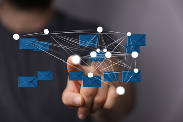 Image of a hand interacting with a network of email icons, representing global communication and connectivity.