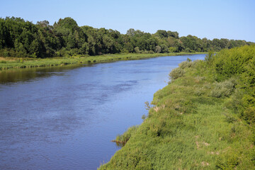 Scenic view of the blue Bug River winding through lush green banks, Podlasie Nadbużańskie, Poland