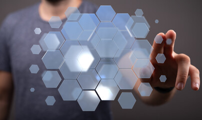 Person touching a digital interface with hexagonal elements. Technology, innovation, future concept.