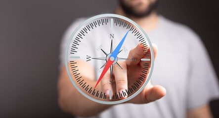 A man interacts with a virtual compass, symbolizing guidance, direction, and strategic planning.