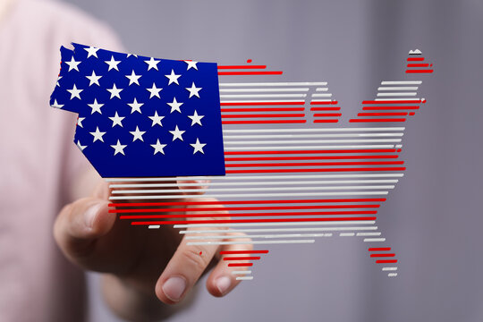 Hand interacting with a digital US map designed with the American flag. Perfect for Independence Day, elections, or patriotism.