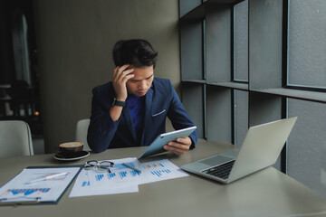 Male office worker overwhelmed by deadlines, staring at screen in frustration.