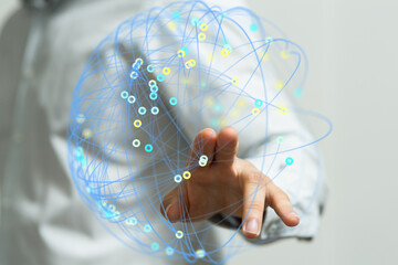 Hand interacting with a digital network.  Illustrates connection, technology, and global communication.