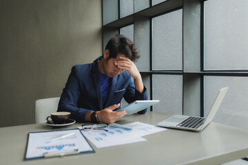 Male office worker overwhelmed by deadlines, staring at screen in frustration.