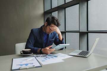 Male office worker overwhelmed by deadlines, staring at screen in frustration.