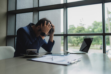 Male office worker overwhelmed by deadlines, staring at screen in frustration.