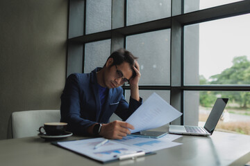 Male office worker overwhelmed by deadlines, staring at screen in frustration.