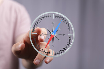 Person interacts with a digital compass, finding direction and guidance.  Concept of navigation,...