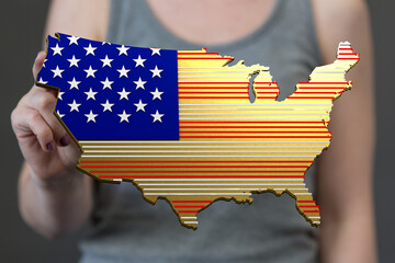 Person displays a stylized US map with an American flag design. Patriotism, nation.