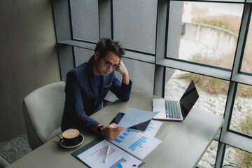 Male office worker overwhelmed by deadlines, staring at screen in frustration.
