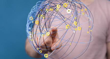 Abstract image of a hand interacting with a digital network sphere, representing global...
