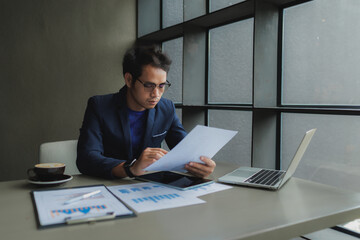Male office worker overwhelmed by deadlines, staring at screen in frustration.
