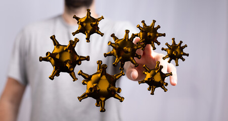 A man interacts with a digital model of viruses, depicting disease or infection.