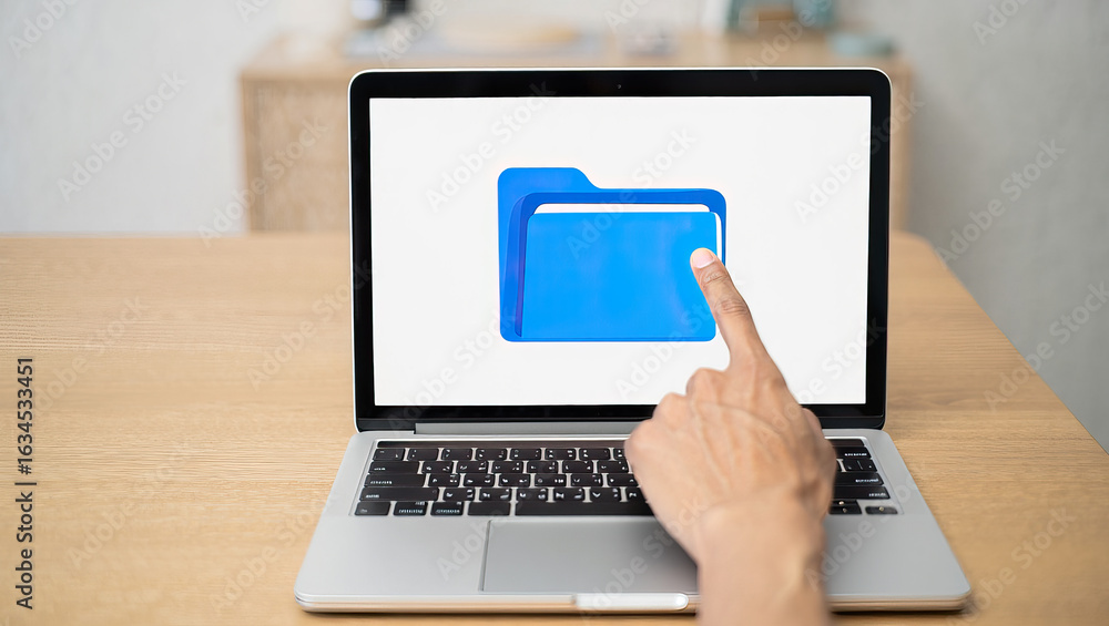 Poster file management a hand interacting with a laptop screen displaying a folder icon on a wooden desk in