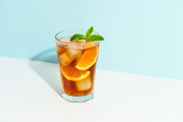 Summer cold drink on colored background with hard shadows.