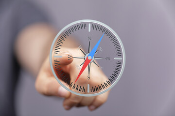 SEO-friendly image of a hand interacting with a digital compass, ideal for navigation, direction,...