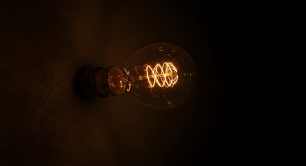 Light bulb glowing in dark.