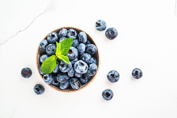 Blueberries in the bowl on white.