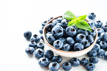 Blueberries in the bowl on white.