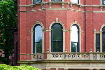 Classic single-family residence with arched windows and ornate balcony in Boston, Massachusetts, USA