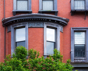 Classic red-brick building with ornate bay window in Boston, Massachusetts, USA
