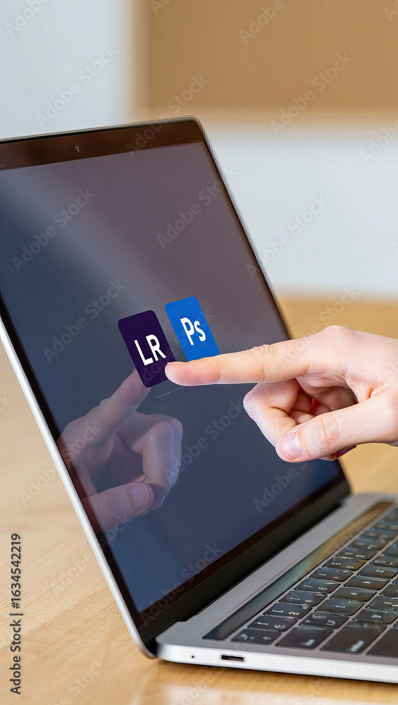 Poster a finger tapping on a laptop screen displaying lightroom and photoshop icons representing digital cr