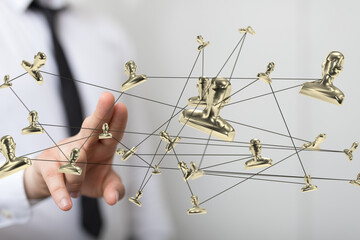 Image of a network of golden figures, symbolizing global connections and teamwork in business.
