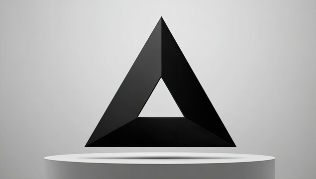 Black, three-dimensional triangle floats on a pedestal