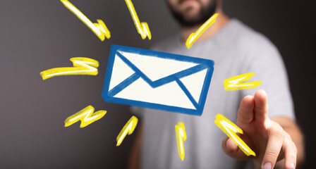 Image of a man interacting with a digital email icon, representing communication and technology.