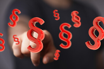 Abstract image of red paragraph symbols floating, representing legal concepts, law, and regulations.