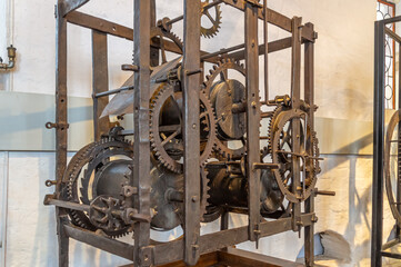 The clock mechanism of the ancient large tower clock in the Tsarskoye Selo Kolomenskoye in Moscow. The clock tower in Kolomenskoye. The ancient mechanism of chimes. Time and life.
