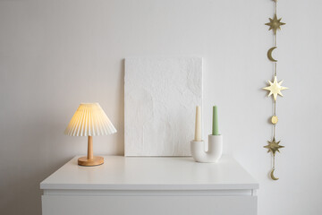 An on table lamp with corrugated shade, painting with putty, candles in curved geometric candle...