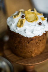 Traditional Easter cakes (kulich) with icing, dried fruits, and nuts on rustic background. Homemade sweet bread, festive pastry for Orthodox Easter, decorated with eggs and spring details.