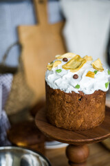 Traditional Easter cakes (kulich) with icing, dried fruits, and nuts on rustic background. Homemade sweet bread, festive pastry for Orthodox Easter, decorated with eggs and spring details.