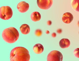 Fresh peaches whirling in air against color gradient background