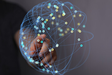 Abstract image depicting a hand interacting with a digital sphere representing global network...