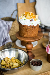 Traditional Easter cakes (kulich) with icing, dried fruits, and nuts on rustic background. Homemade sweet bread, festive pastry for Orthodox Easter, decorated with eggs and spring details.