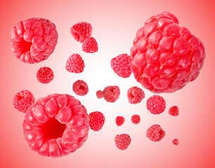 Fresh raspberries swirling in air against pink gradient background