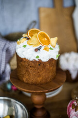 Traditional Easter cakes (kulich) with icing, dried fruits, and nuts on rustic background. Homemade sweet bread, festive pastry for Orthodox Easter, decorated with eggs and spring details.