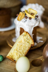 Traditional Easter cakes (kulich) with icing, dried fruits, and nuts on rustic background. Homemade sweet bread, festive pastry for Orthodox Easter, decorated with eggs and spring details.