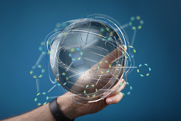 Futuristic concept of global network technology.  A hand holds a transparent sphere with digital...