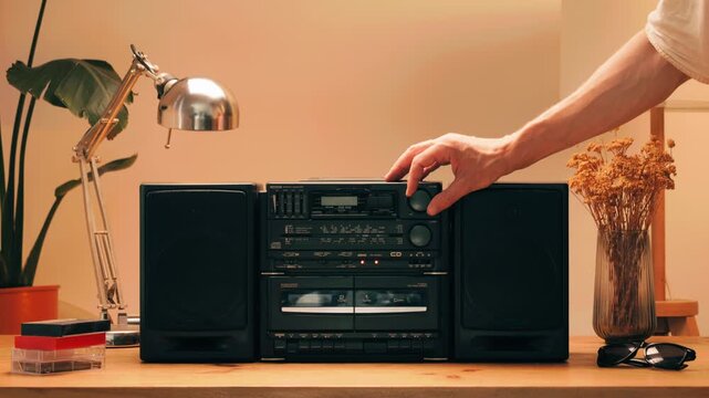 Retro radio tape recorder, audio cassette close-up. Listening to music, old radio boom box player, macro of vintage music listening. 