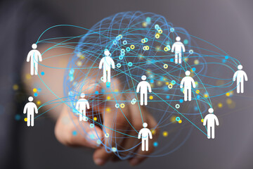 Hand interacting with a digital network visualization.  Connecting people globally.