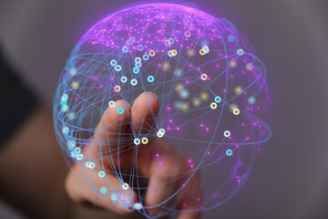 Abstract image of a hand interacting with a glowing digital network sphere. Represents global...
