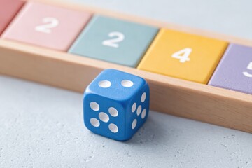 Colorful numbers contrast with blue die, illustrating chance and