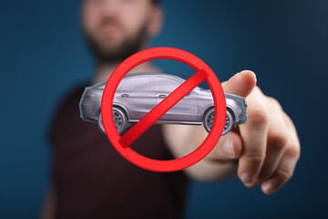 Image of a hand holding a no cars allowed sign. Perfect for driving restrictions, parking...