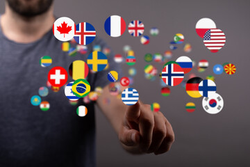 Person touching digital flags, representing international communication and global reach.